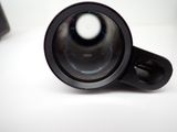 a close up of a camera lens on a white surface