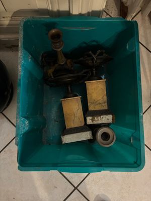 a blue container filled with tools on a tiled floor