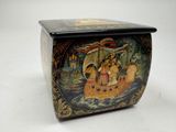 a small box with a painting on it on a table