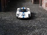 a white and blue sports car parked on a cobblestone street