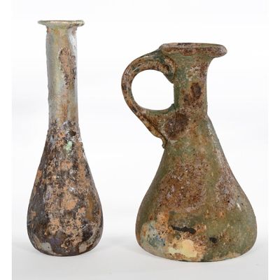 two vases sitting next to each other on a white surface