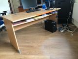 a computer desk with two monitors and a keyboard on it
