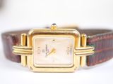 a close up of a wrist watch with a brown leather band