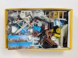 a box full of assorted legos on a white surface