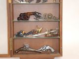 a display case with several different types of guns on it