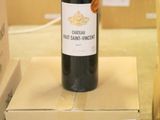 a bottle of wine sitting on top of a cardboard box