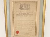 un document encadré portant un cachet de cire rouge