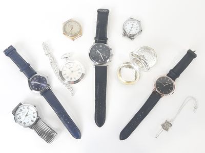 many different types of watches laid out on a white surface