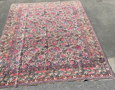 an old rug is laying on the ground in a parking lot