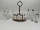 a lot of glass bottles and vases sitting on a table