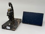 a statue of a man holding a bird on a marble base