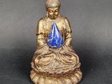 an image of a statue of a person sitting on a lotus