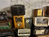 many old radio ' s stacked on top of each other