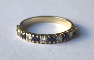 an image of a gold ring with blue and white stones