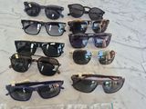 several pairs of sunglasses are on a table with a price tag