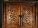 a large wooden cabinet with a cross on the door