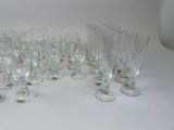 many empty wine glasses lined up on a table
