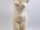 sculpture of a female torso on a wooden base on a white background