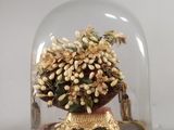 une cloche en verre renfermant un vase de fleurs