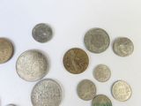 a lot of coins that are on a white surface