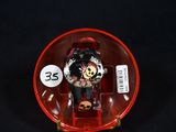a watch with a skeleton on it in a red case