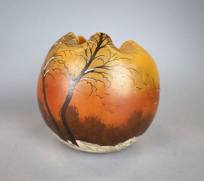 a vase with a tree on it sitting on a table
