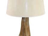 table lamp in the shape of a bird ' s foot with a white shade