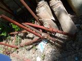 a pile of old rusty pipes and pipes in the yard