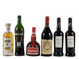 several bottles of alcohol are lined up on a white surface
