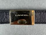 an image of a black leather belt with a gold buckle