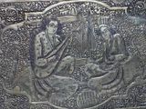 a silver box with a picture of a man and a dog on it