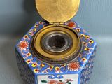 an image of a small blue and white box with a gold lid