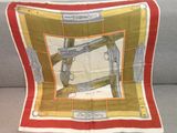 a close up of a red and yellow scarf with guns on it