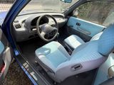 l'intérieur d'une petite voiture avec des sièges bleus et un volant