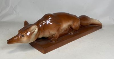an image of a statue of a rat on a wooden base
