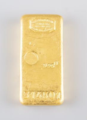 a close up of a gold bar on a white surface
