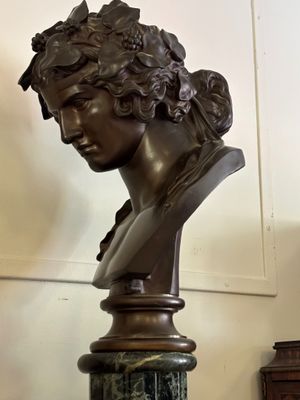 a bust of a woman on a pedestal in a room