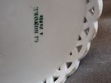 a white plate with green writing on it sitting on a table