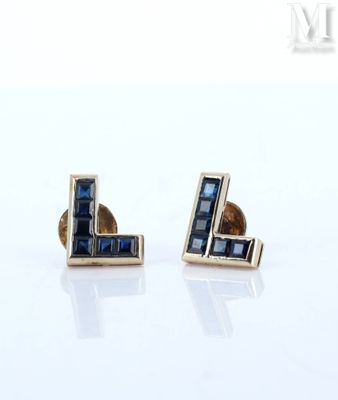 pair of earrings with blue sapphires on a white background