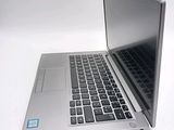 a silver laptop computer sitting on top of a white table