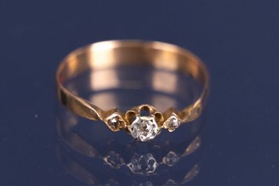 a close up of a gold ring with a diamond