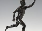an image of a bronze statue of a man running on a marble base
