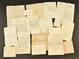 several old letters and papers are piled together on a table