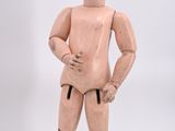 a wooden mannequin that is standing on a white surface
