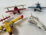 four toy airplanes that are sitting on a table