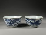 pair of blue and white bowls with dragon handles