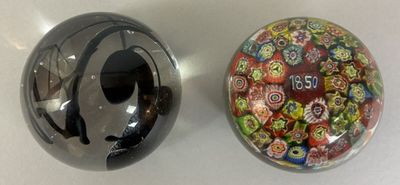 two glass objects sitting on a table next to each other