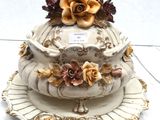 a three tiered cake on a plate with flowers on it