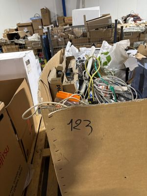 a large pile of cardboard boxes in the middle of a room