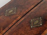 a wooden chest of drawers with brass hardware on it